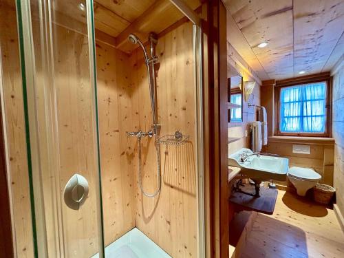 a bathroom with a shower and a sink at 300 years old Chalet close to Center ski-lift in Chateau-d'Oex