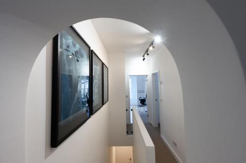 a hallway with a large painting on the wall at Swift Host - 2 Bedrooms - Apartment - Great Location - Parking in Norwich