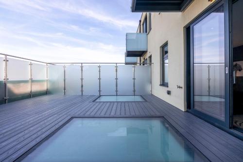 a balcony with a swimming pool on a building at Palm Tree House Apartments in Farnborough