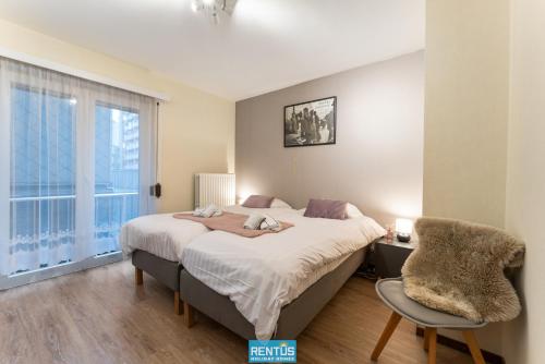 Ένα ή περισσότερα κρεβάτια σε δωμάτιο στο Noordzeecocoon - enjoy side sea view