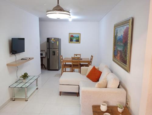 a living room with a couch and a table at Ciudad Juan Bosch StoDgo este in La Javilla