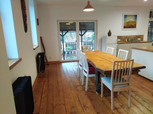 a kitchen and dining room with a wooden table and chairs at Old Hunting Lodge in Karlovy Vary