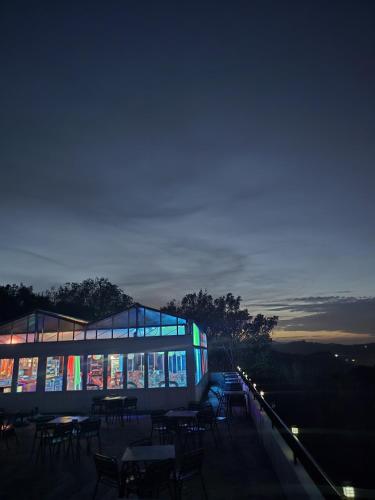 a lit up building with tables and chairs at night at Matzuri Nekazal Turismoa in Mutriku
