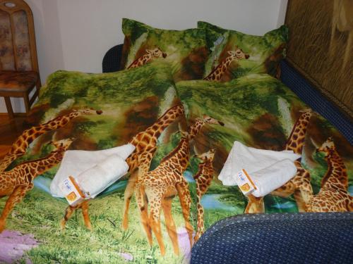 a bed with a bunch of giraffes on it at Joe Apartman Budapest in Budapest