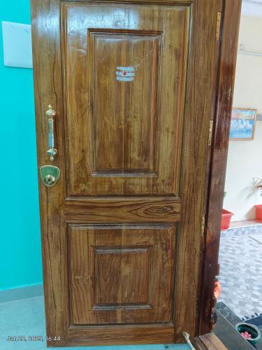an old wooden door with a sticker on it at villaa eden in Puducherry