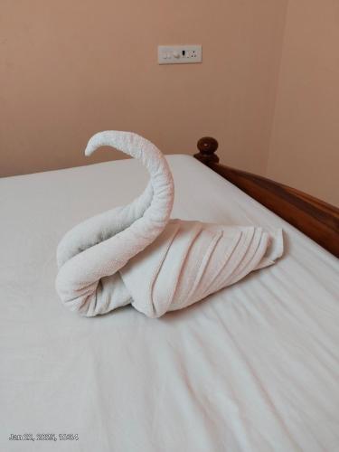 a swan made out of towels on a bed at villaa eden in Puducherry