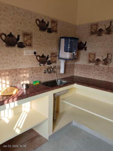 a kitchen with a sink and a tv on the wall at villaa eden in Puducherry