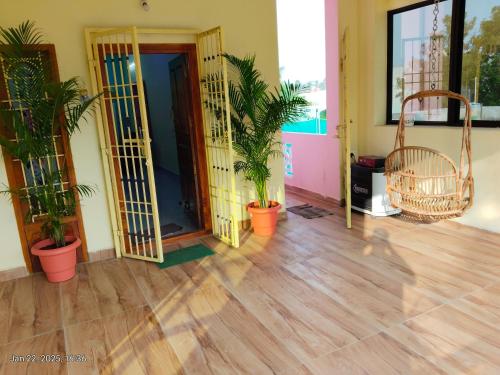 an empty room with potted plants and a door at villaa eden in Puducherry