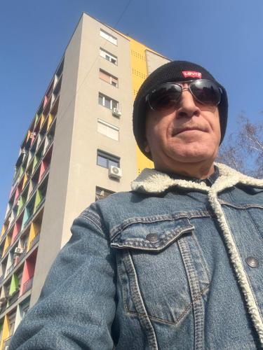 a man standing in front of a building at CENTRAL ROOMS WITH GREAT VIEW shared bathroom no parking in Skopje