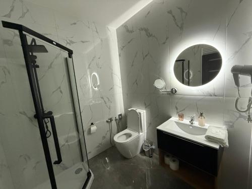 a bathroom with a toilet and a sink and a mirror at Vrbecká restaurace-penzion 7 in Hrubá Vrbka