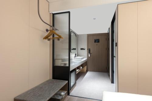 a bathroom with a sink and a mirror at Atour Hotel Guilin Elephant Trunk Hill Sun and Moon Twin Pagodas in Guilin