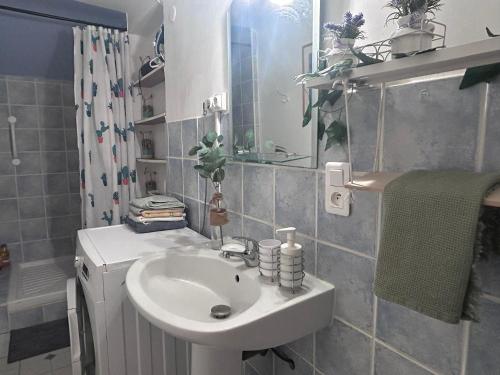 a bathroom with a white sink and a shower at La Soleillade in Manosque
