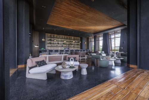 a lobby with couches and tables and a bar at Serengeti Explorer in Serengeti