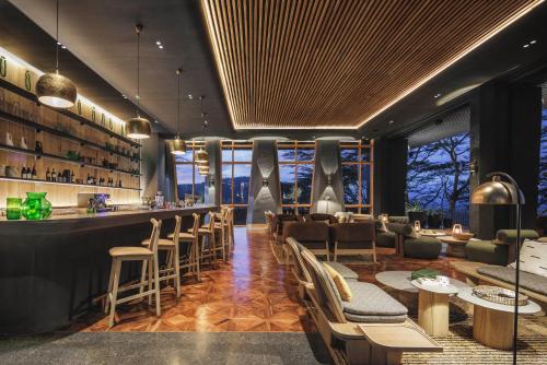 a restaurant with a bar with chairs and tables at Serengeti Explorer in Serengeti