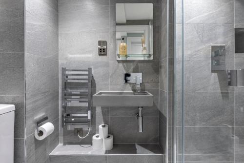 a bathroom with a sink and a shower at Argyle - Stunning 5 bed Luxury Home - Pulteney Bridge, Bath in Bath