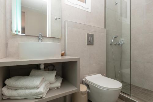 a bathroom with a sink and a toilet and a shower at Anadiomeni Pool & Beach Apartments by "elite" in Zakynthos