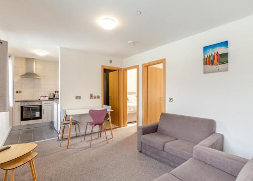 a living room with a couch and a table at Apartment with Access to Pool Spa & Soft play in Ilfracombe