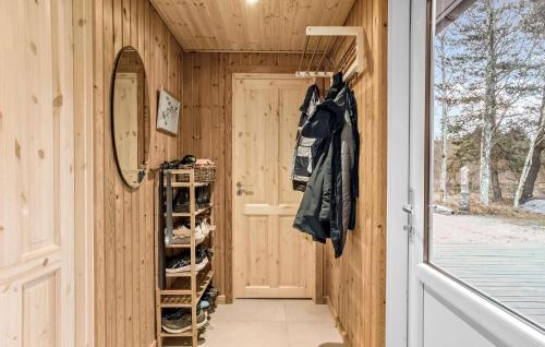 a hallway of a wooden house with a mirror and a door at Cozy Home In Jerup With Wifi in Jerup