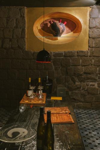 a room with a table with bottles of wine at Atelier Inès Arts & Suites in Naples