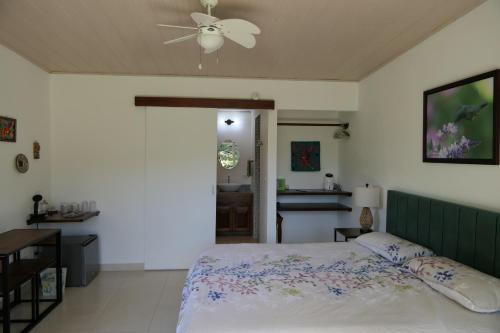 a bedroom with a bed and a ceiling fan at Casitas Vista Verde in Bajo Boquete