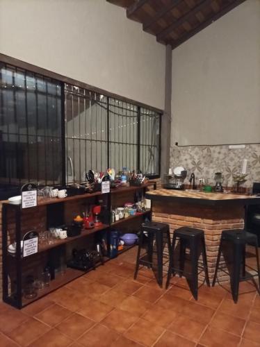 a room with tables and chairs and a counter at Habitaciones Dos Antonios in Puerto Vallarta