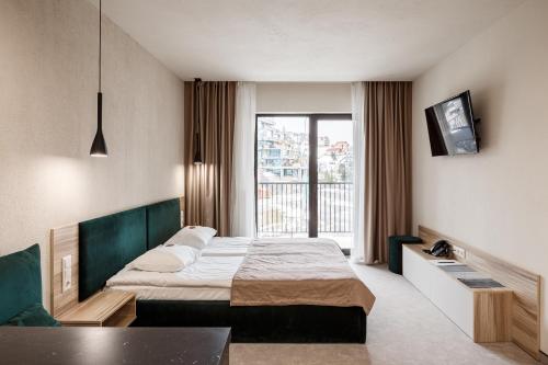 Postel nebo postele na pokoji v ubytování HVOYA Apart-Hotel & SPA
