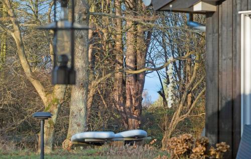 a group of blue lounges in front of a tree at 5 Bedroom Nice Home In Fårevejle in Fårevejle