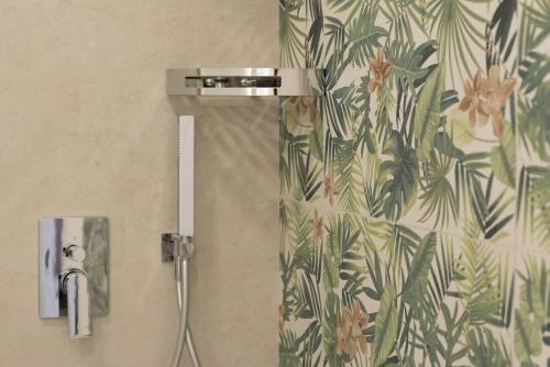 a shower head and a phone on a wall at Le Secche Suite & House 2 by Salento Prime in Torre Pali 