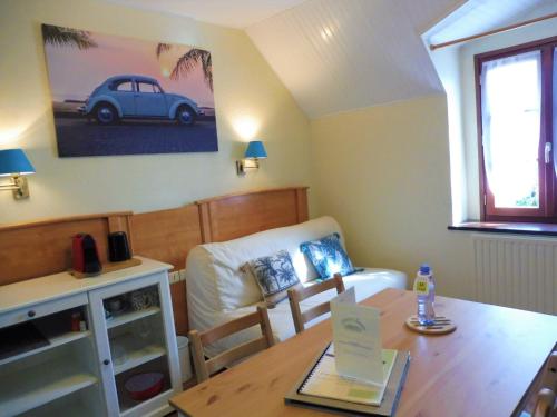 a living room with a table and a couch at Logis Auberge De Launay in Limeray