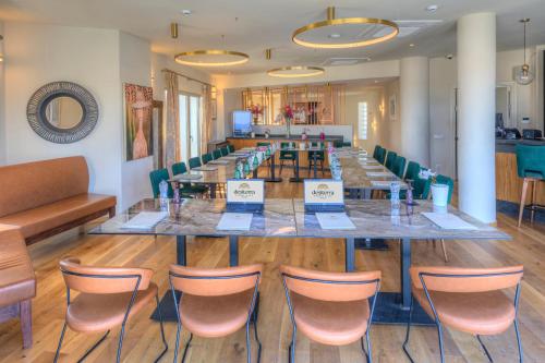 a long table and chairs in a room at Desiterra Resort & Spa in Fira