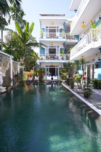 a swimming pool in front of a building at Tranquil Lucky Leaf Villa in Hoi An