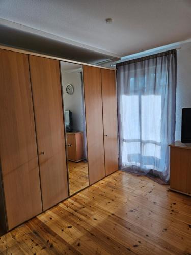 an empty room with a window and wooden floors at Seeblick III in Bad Saarow