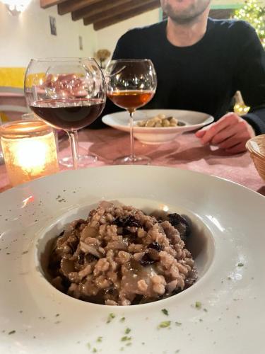 a man sitting at a table with a bowl of food and wine at Nema in Mossa