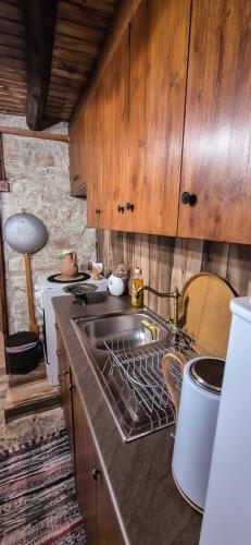 a kitchen with a sink and a stove top oven at Angels Traditional House in Arminou