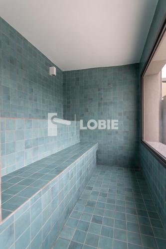 a blue tiled bathroom with the words ludic at Lobie Gloria Del'Art in Rio de Janeiro