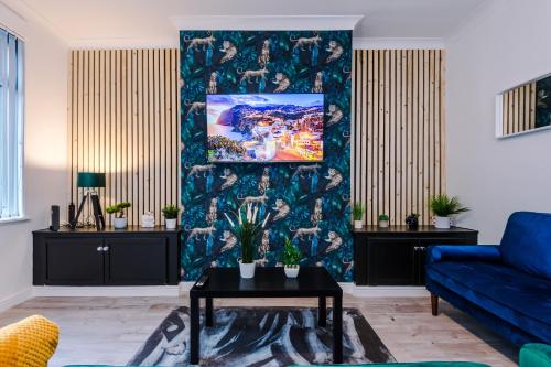 a living room with a blue couch and a wall at Beautiful Home In Bolton in Bolton