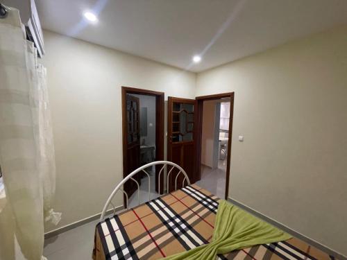 a small bedroom with a bed in a room at Suites Home Tarrafal in Tarrafal