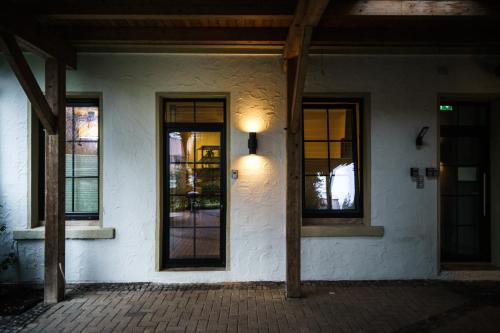 a building with windows and a light on the side at Boardinghaus Grünefeld W4 I by WOOON I Küche I Smart TV I P I Rainshower in Mettingen