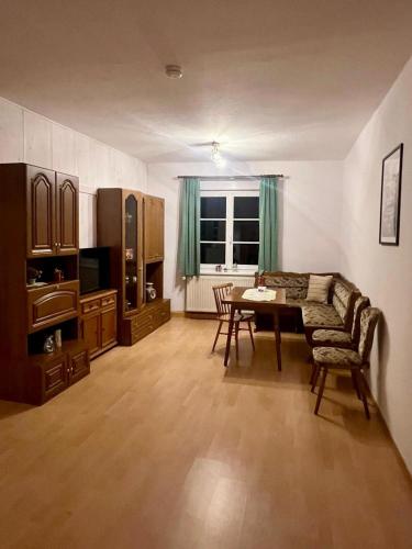 a living room with a couch and a table at Adler 3 in Pulsnitz