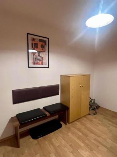 a room with a bench and a table and a light at Adler 3 in Pulsnitz
