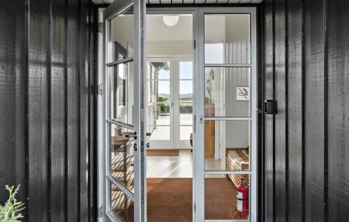 a glass door leading into a house at Cozy Home In Nysted With Sauna in Nysted