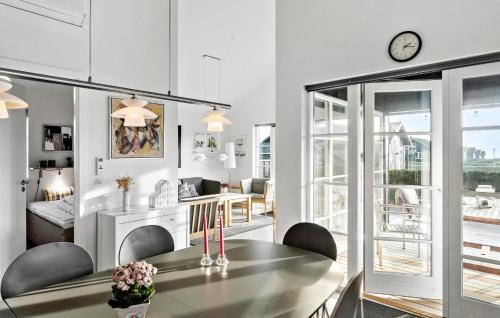a kitchen and living room with a table and chairs at Cozy Home In Nysted With Sauna in Nysted