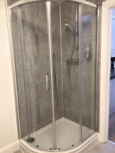 a shower with a glass door in a bathroom at 8 Ashbrook Mews in Blewbury