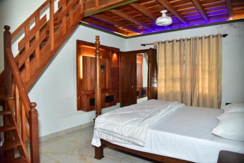 a bedroom with a bed and a wooden staircase at Mountain Breeze Coorg in Madikeri