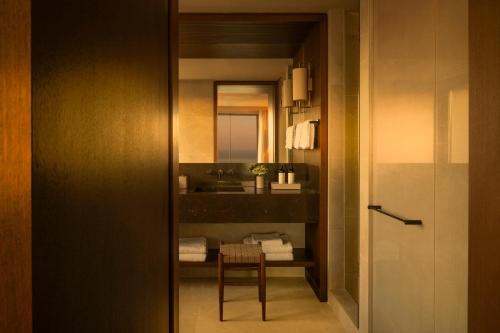 a bathroom with a sink and a table and a mirror at Fairmont La Hacienda Costa del Sol in Alcaidesa