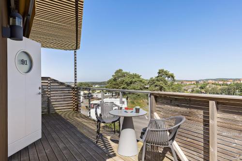 a patio with a table and chairs on a balcony at First Camp City-Strömstad in Strömstad