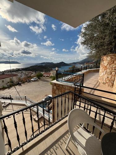 a balcony with two chairs and a view of the ocean at Carpediem Apart in Kas