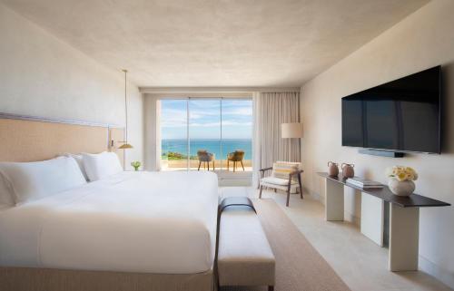 a hotel room with a large bed and a television at Fairmont La Hacienda Costa del Sol in Alcaidesa