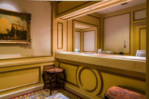 a bathroom with a sink and a mirror at Rihga Royal Hotel Tokyo in Tokyo