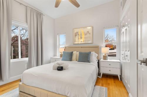 a white bedroom with a large bed and two windows at Spacious and Central DC 3-BR Getaway Close to It All in Washington, D.C.